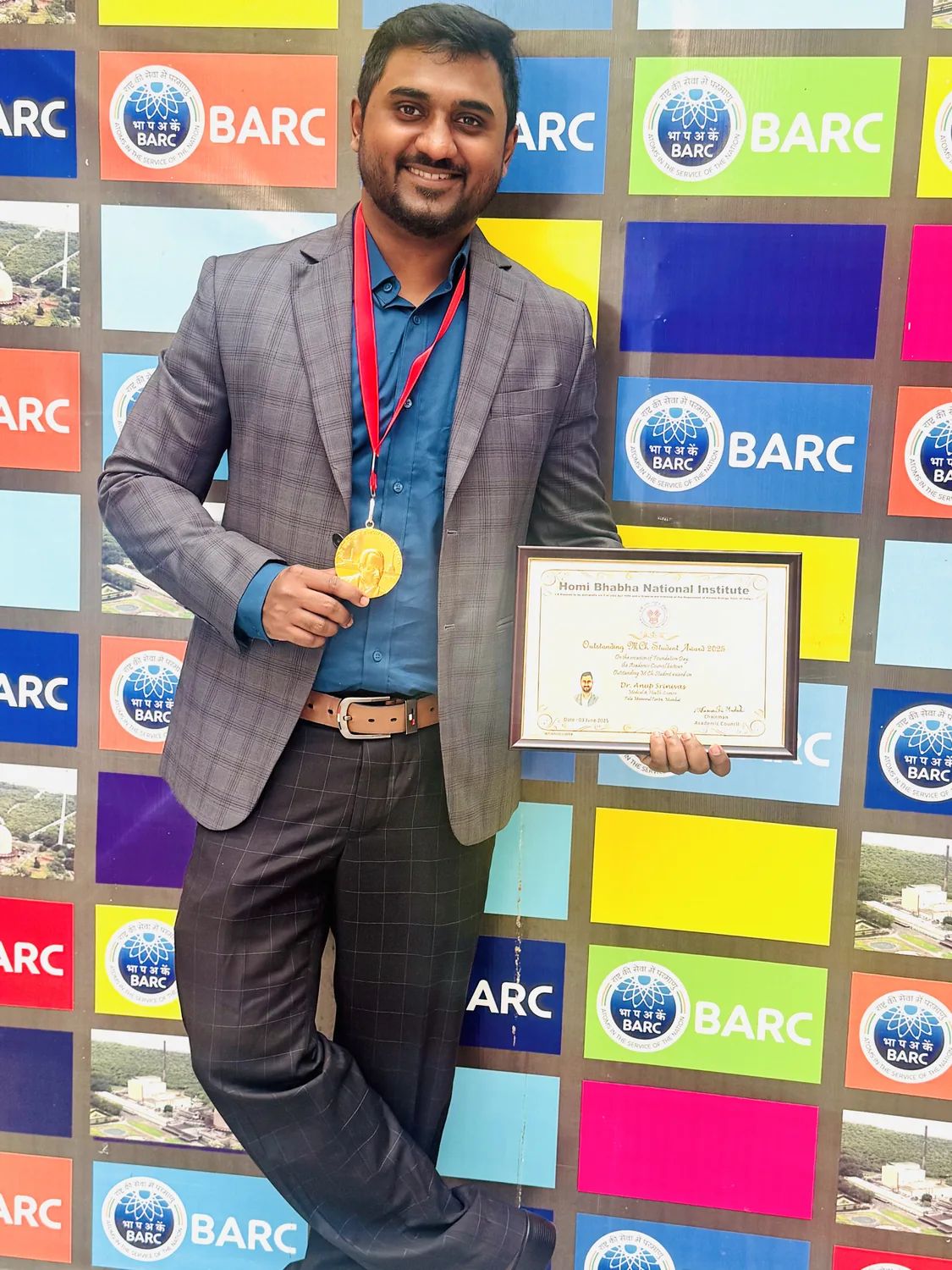 Dr Anup Srinivas with medal and certificate